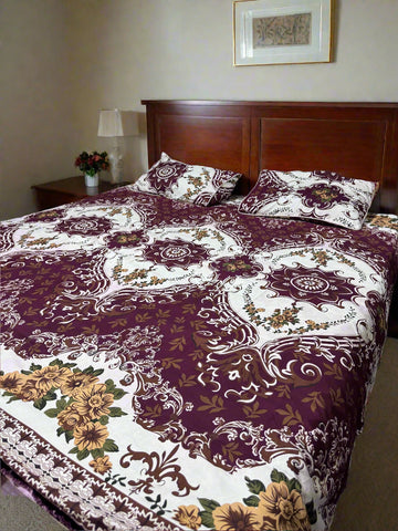 Bed with floral patterned bedspread and pillows against a wooden headboard.